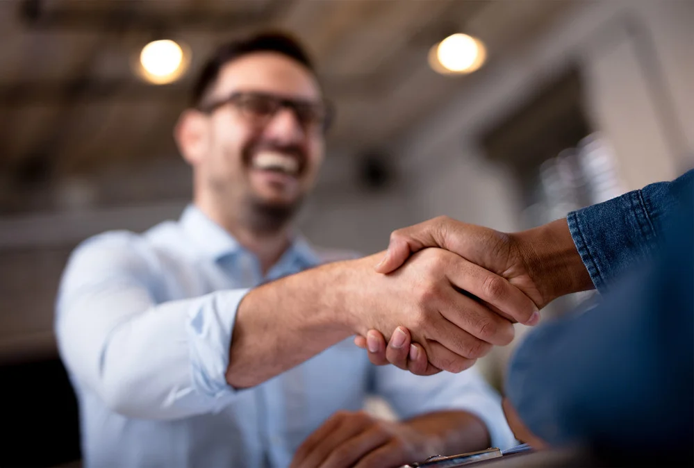 Business professionals shaking hands after a meeting
